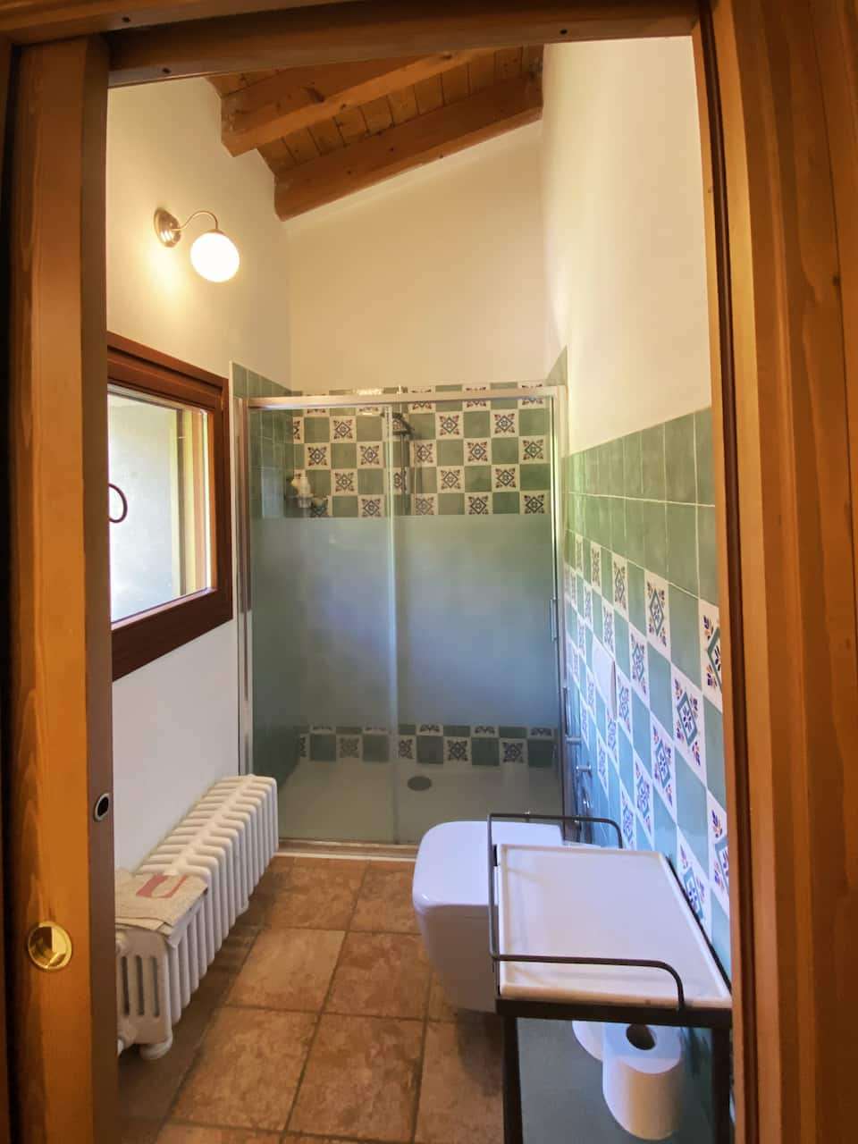 Upstairs bathroom with green tiles