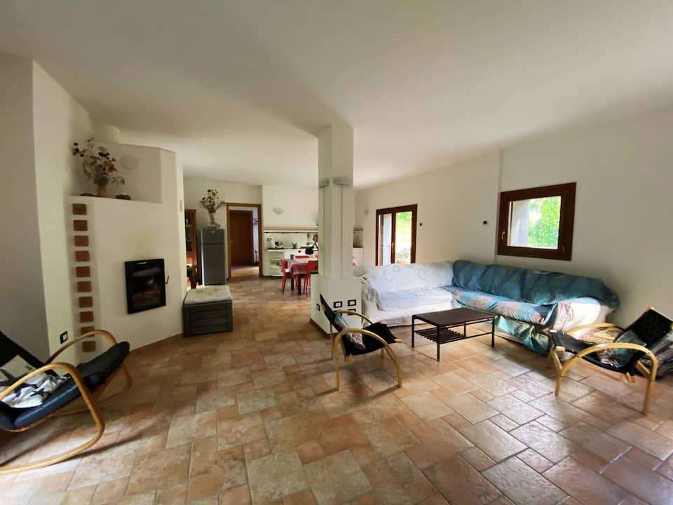 Open-plan living area with sofas and terracotta floors